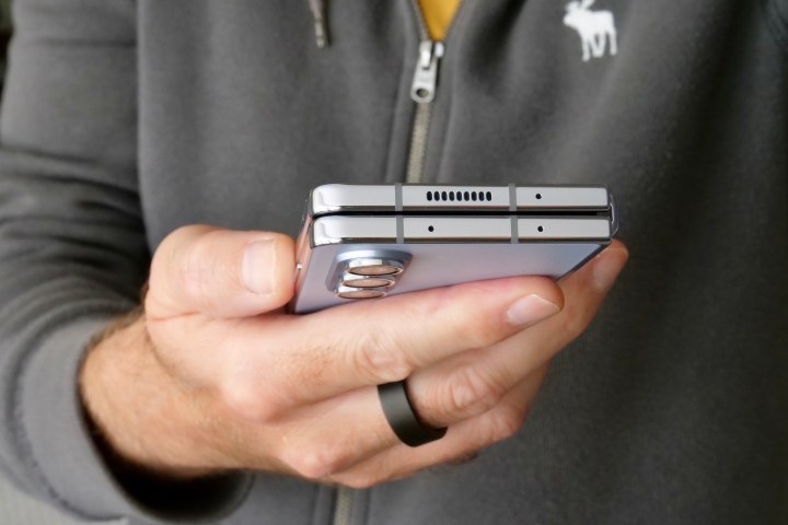 A person holding the Samsung Galaxy Z Fold 5, showing the top.