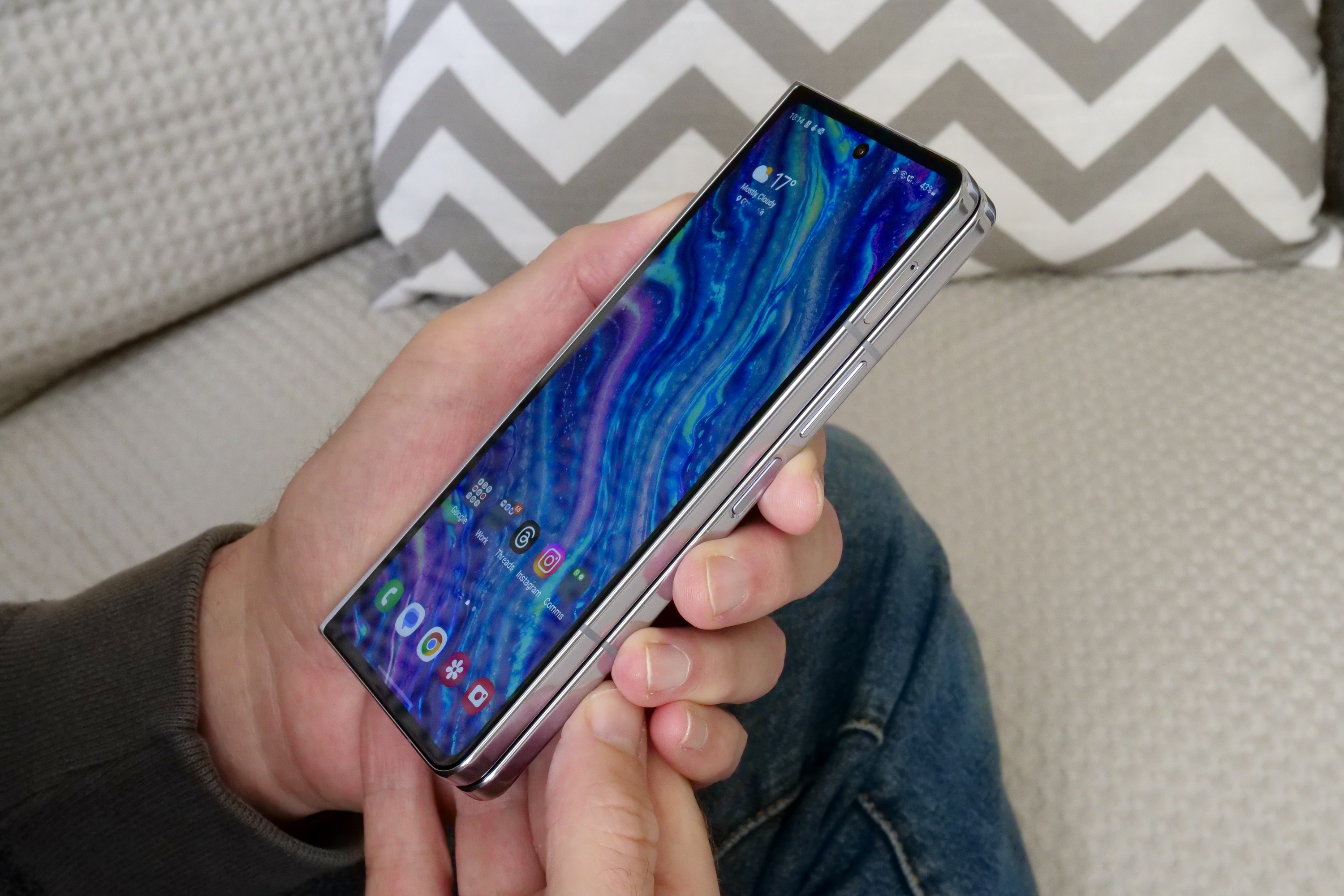 A person holding the Samsung Galaxy Z Fold 5, seen from the side.
