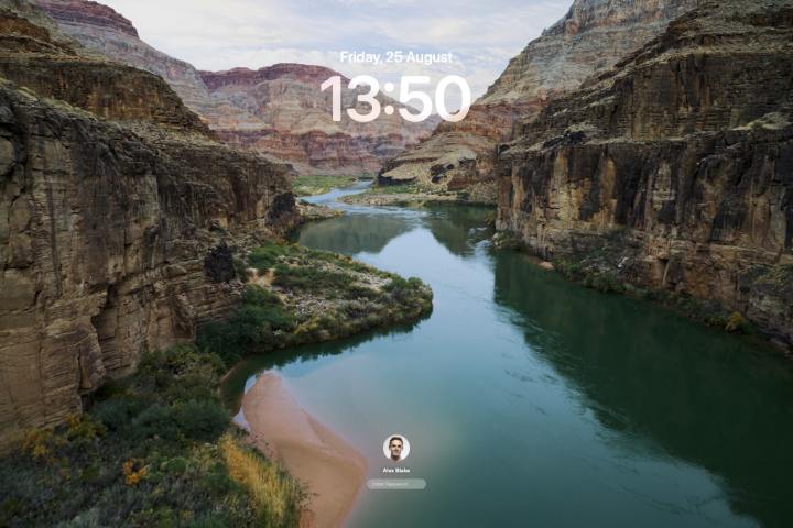 The Lock Screen in macOS Sonoma, with a video screen saver playing in the background.