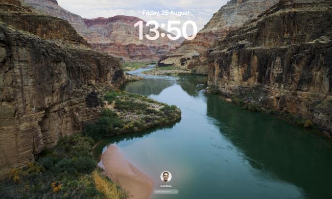The Lock Screen in macOS Sonoma, with a video screen saver playing in the background.