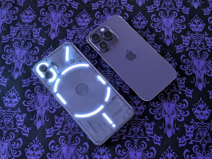 Nothing Phone 2 lit up next to an iPhone 14 Pro.