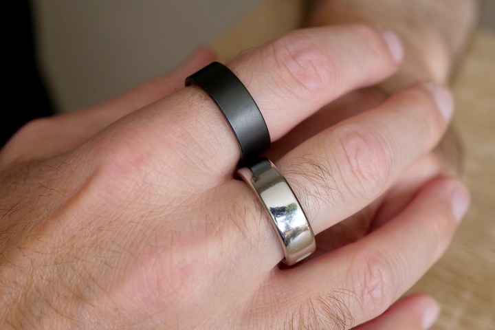 A person wearing the Ultrahuman Ring Air and the Oura Ring.
