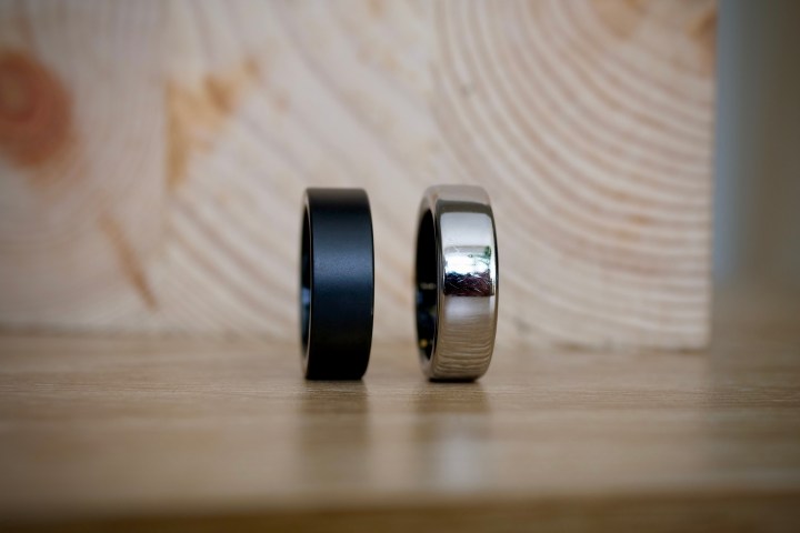 The Ultrahuman Ring Air and the Oura Ring, resting on a table.