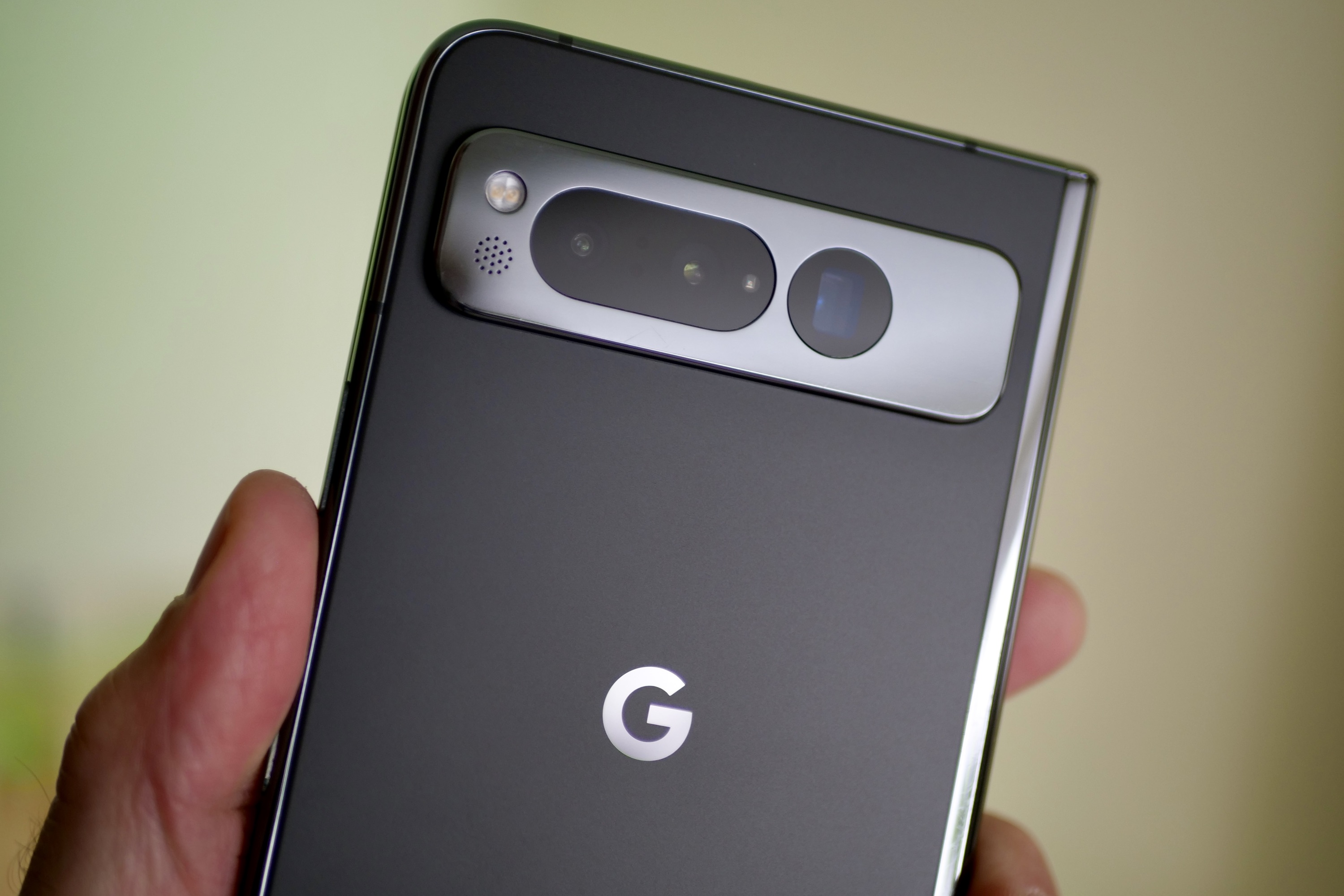 A person holding the Google Pixel Fold, showing the camera module.