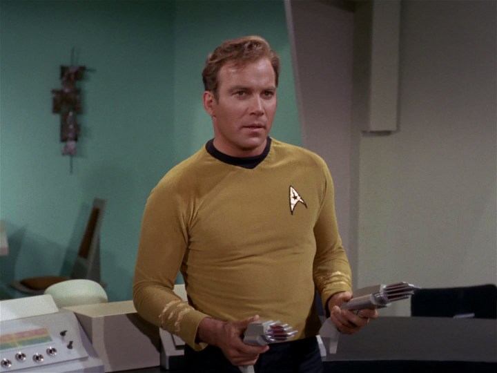 Captain Kirk aims two disruptors in Star Trek's "A Taste of Armageddon"