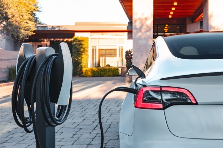 A Tesla car chargers on a Tesla Destination charger.