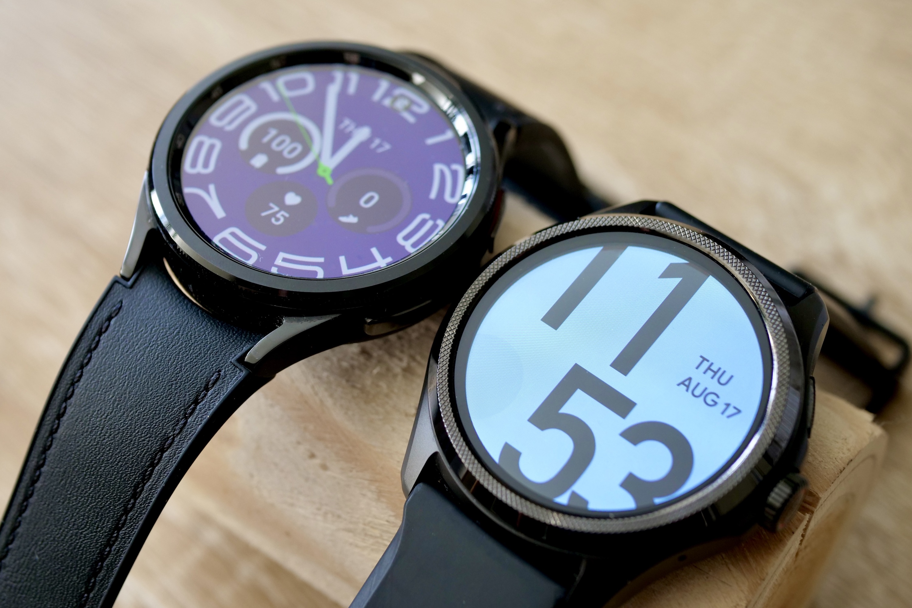 The Mobvoi Ticwatch Pro 5 and Samsung Galaxy Watch 6 Classic, showing different watch faces.