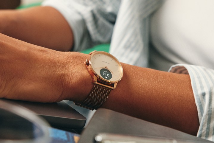 A person wearing the Withings ScanWatch Light.