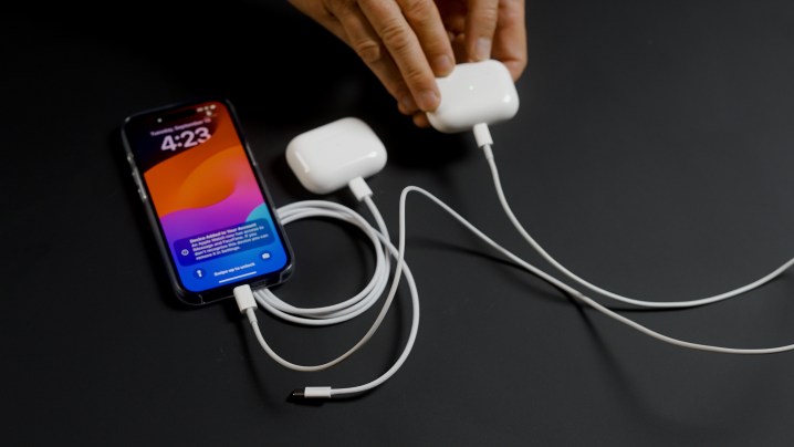 A phone charging the Apple AirPods Pro 2 with USB-C via Lightning cable.