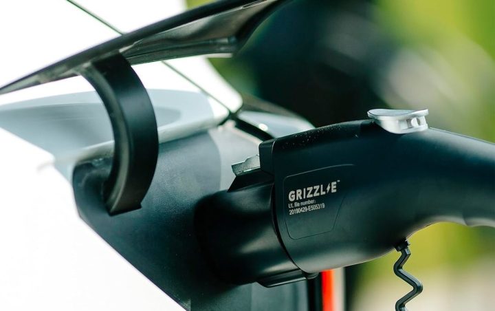 The handle of the Grizzl-E EV charger plugged into a vehicle.
