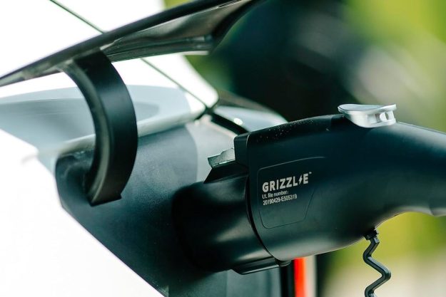 The handle of the Grizzl-E EV charger plugged into a vehicle.