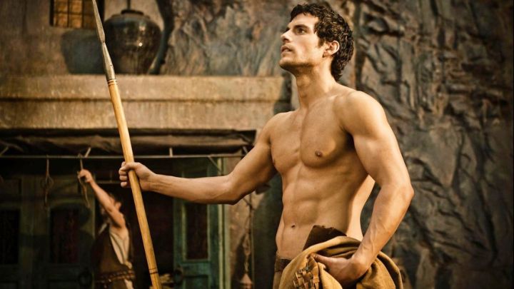 Henry Cavill as Theseus holding a spear and looking up in the 2011 movie Immortals.