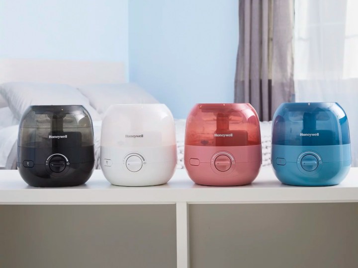A range of different colors of the Honeywell Mini Mist 0.5-gallon humidifier setting on a cabinet.
