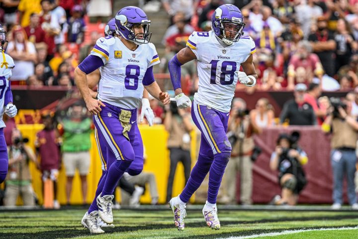 Kirk Cousins and Justin Jefferson run on the field for the Minnesota Vikings.