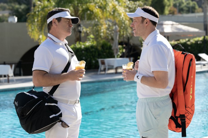 Nick Offerman and Seth Rogen stand near a pool in Dumb Money.