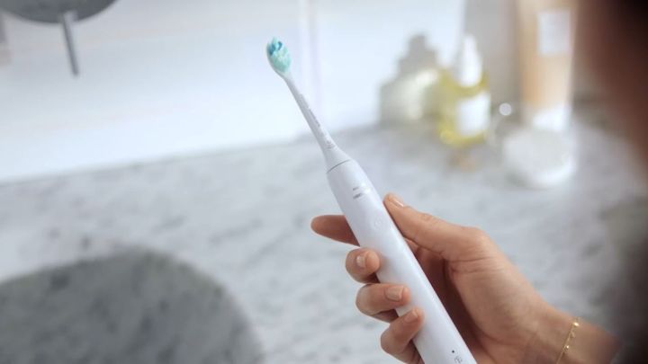 A person holding the Philips Sonicare 4100.