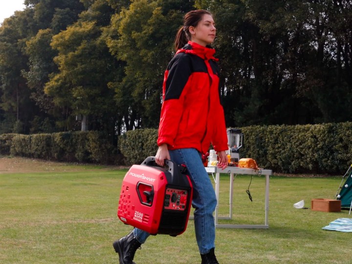 Carrying the PowerSmart 2500W Portable Inverter Gas Gasoline Powered Generator at an outdoor gathering.