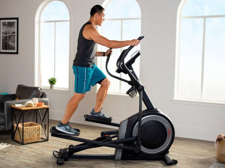 A man is exercising on a Proform Carbon EL while gazing out the window.