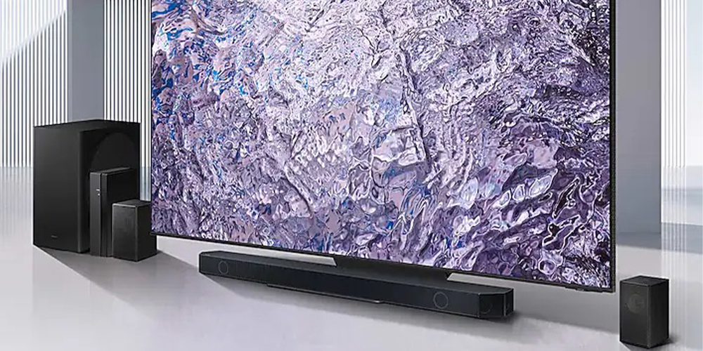 The Samsung Q910C soundbar underneath a huge TV.