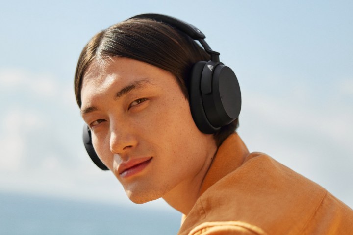 A model wearing Sennheiser Accentum wireless headphones in black.