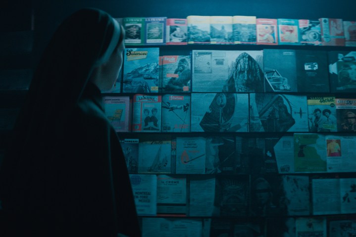 Sister Irene looks at a magazine collage of Valak in The Nun 2.