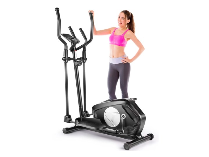 A woman stands with the Vibespark 8-level elliptical machine against a white background.