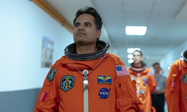 Michael Peña as José in a spacesuit walking down a hall in the movie A Million Miles Away.