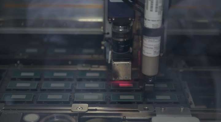 A machine applies adhesive over the substrate before the IHS is fixed on top of the dies. 