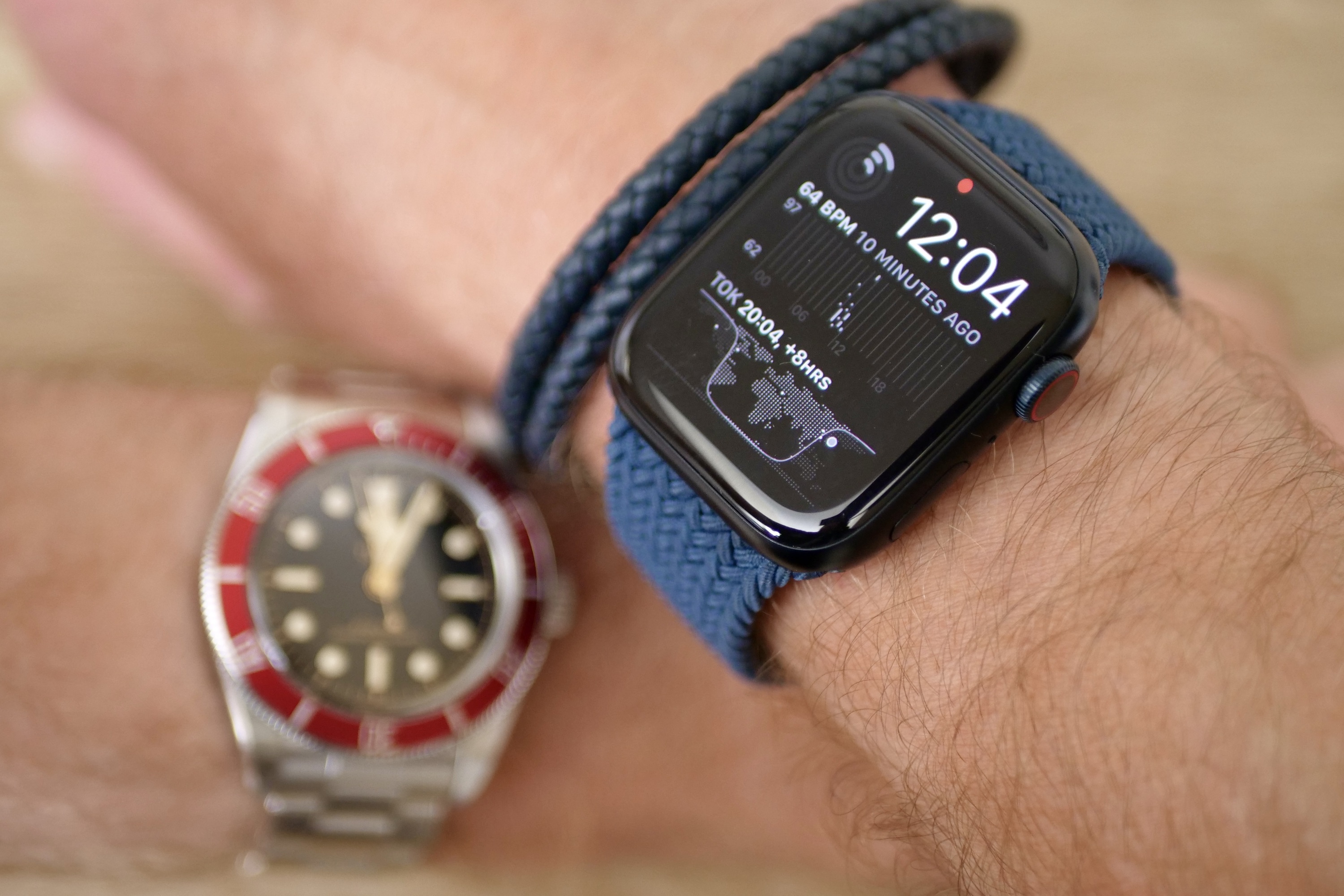 A person wearing the Apple Watch Series 8, with a Tudor Black Bay on the other wrist.