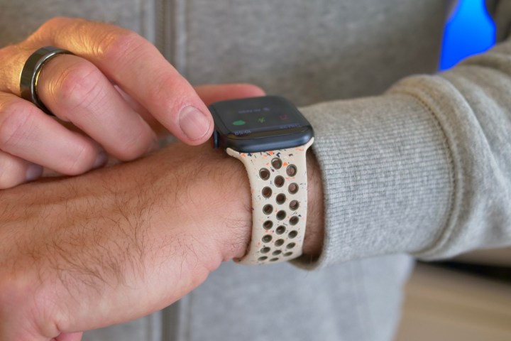 A person wearing the Apple Watch Series 9, using the Digital Crown.