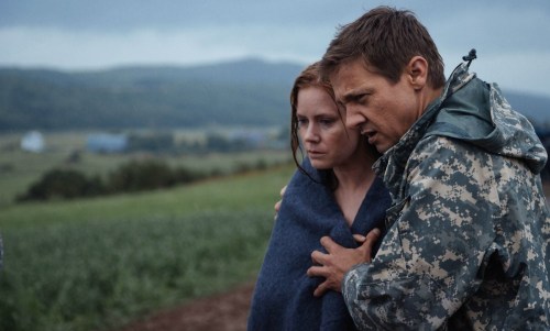 A man helps a woman in Arrival.