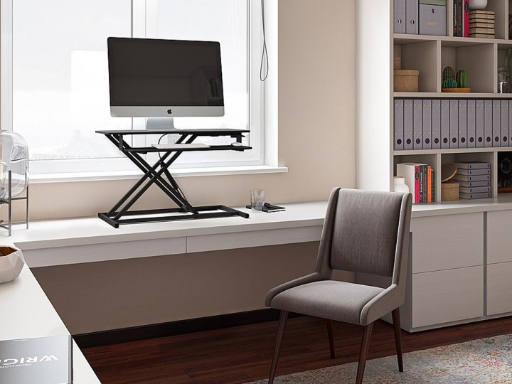 The CorLiving standing desk converter extended on a desktop.