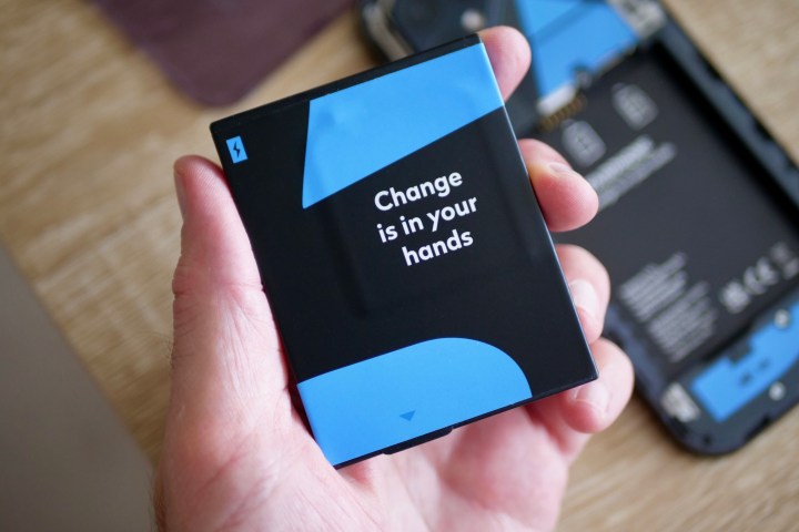 A person holding the Fairphone 5's battery.