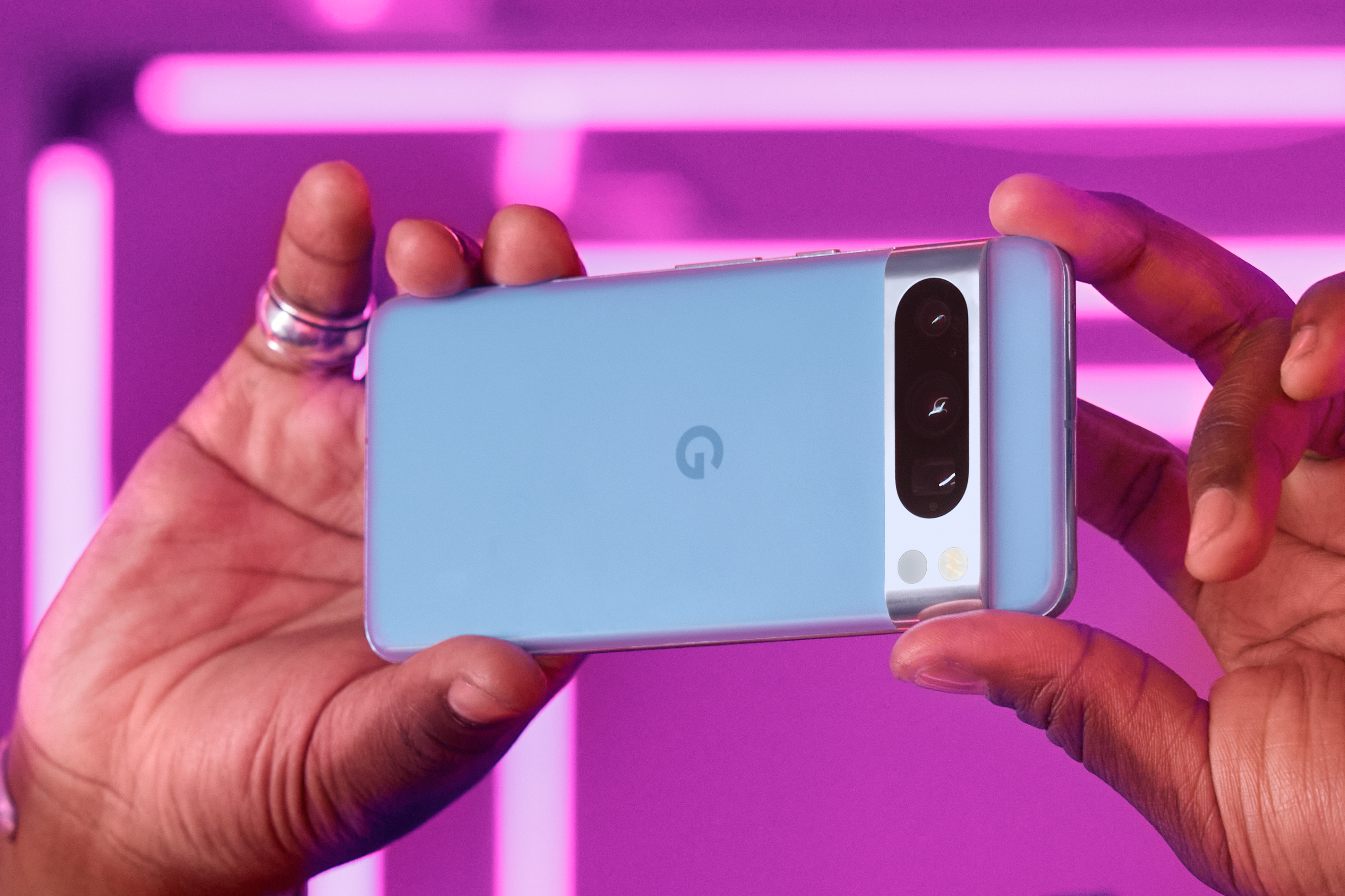 Someone holding up a blue Google Pixel 8 Pro.