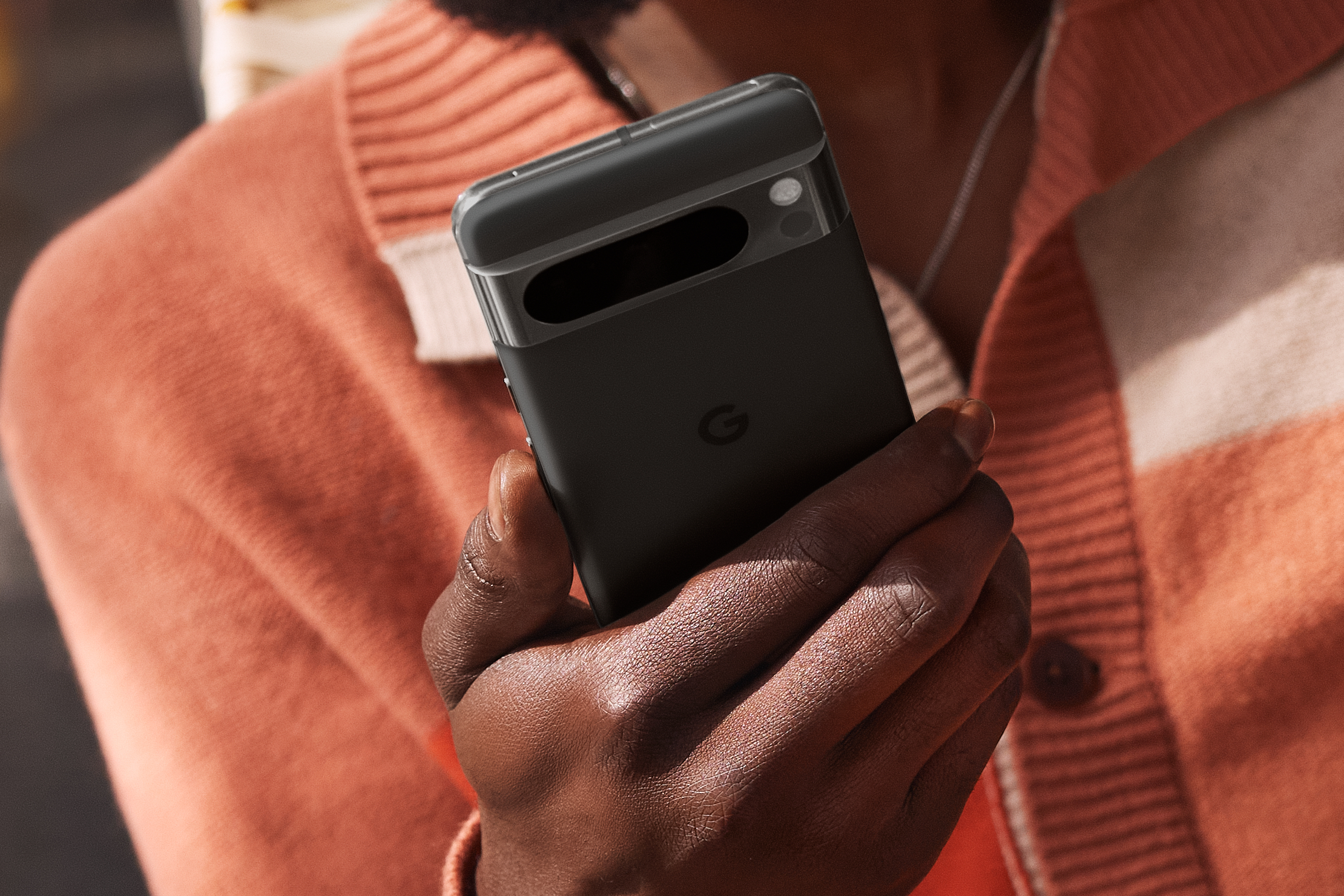 Someone holding a black Google Pixel 8 Pro.