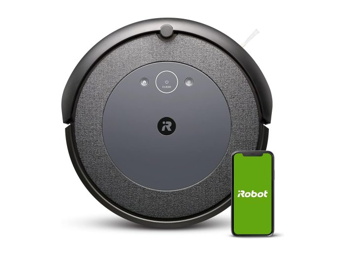 The iRobot Roomba i4 EVO behind a phone with the iRobot app open.