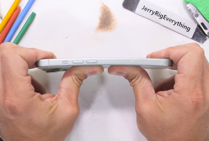 YouTuber Zack Nelson bending an iPhone 15 to test its strength.