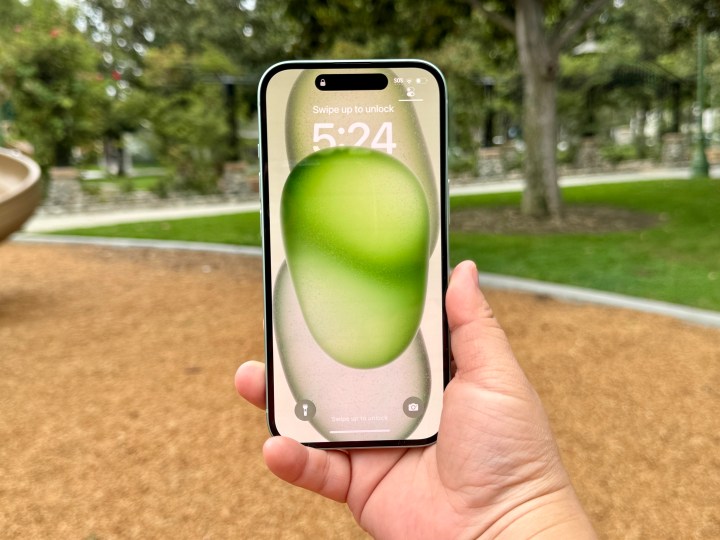 A green iPhone 15 lock screen.