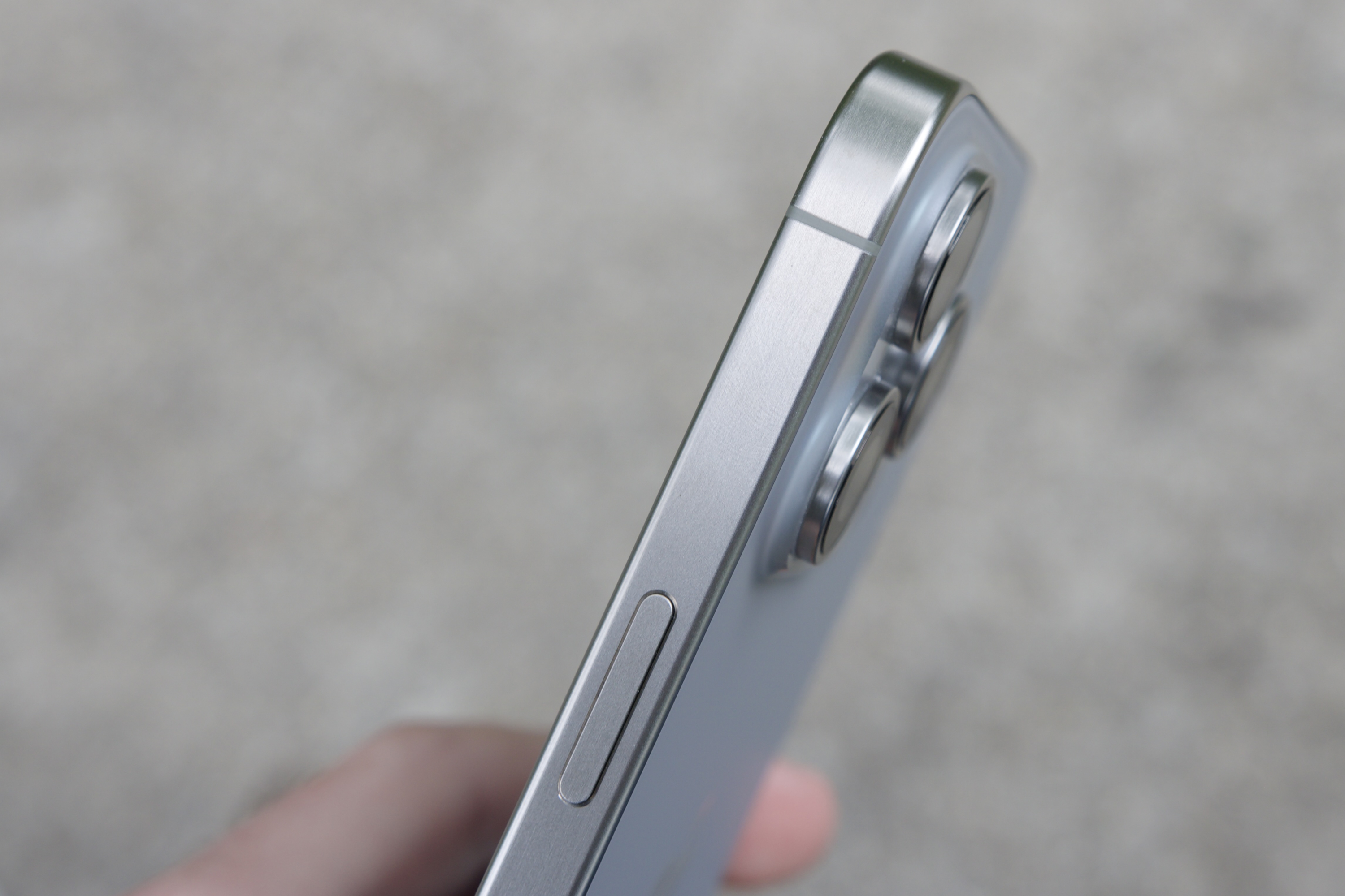 Close-up view of titanium frame on iPhone 15 Pro Max.