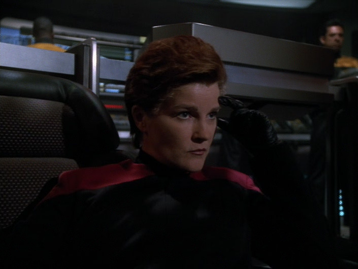 Evil Captain Janeway on the darkened bridge of Warship Voyager in Living Witness.