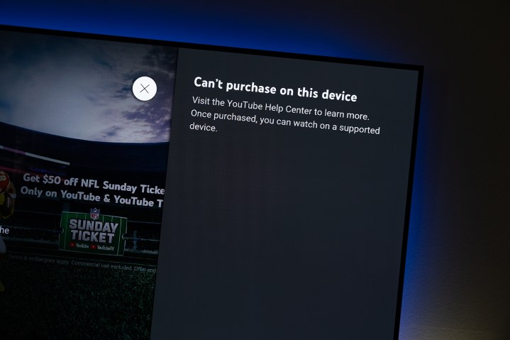 A screen on Apple TV that says "Can't purchase on this device. Visit the YouTube Help Center to learn more. Once purchased, you can watch on a supported device."