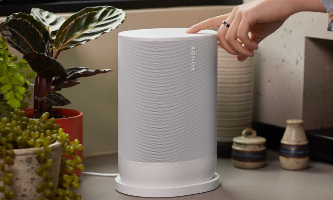 Sonos Move 2 in white, sitting on charging base.