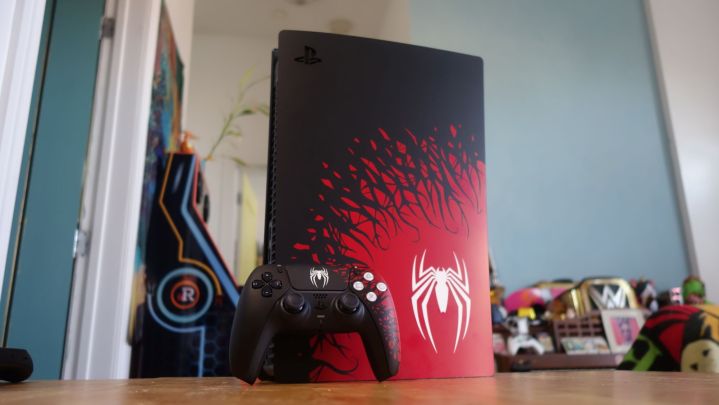 The Spider-Man special edition PS5 and controller stand on a table.