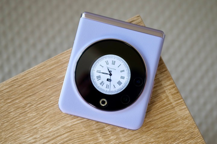 The Tecno Phantom V Flip's cover screen showing a clock face.