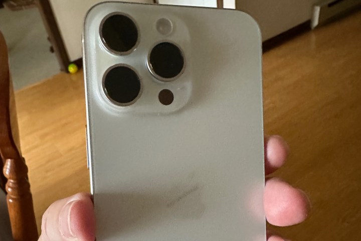 The back of the iPhone 15 Pro Max, being held in someone's hand.