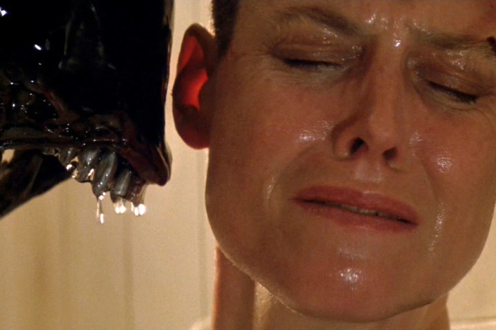 A Xenomorph snarls at Sigourney Weaver in Alien 3.