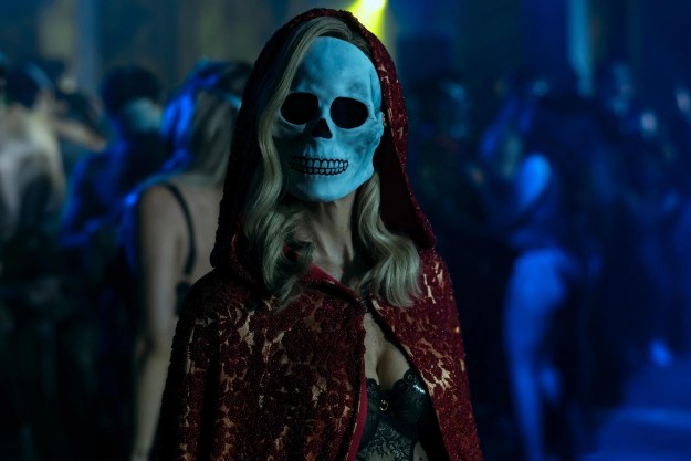A blonde-haired woman wears a skull mask in The Fall of the House of Usher.