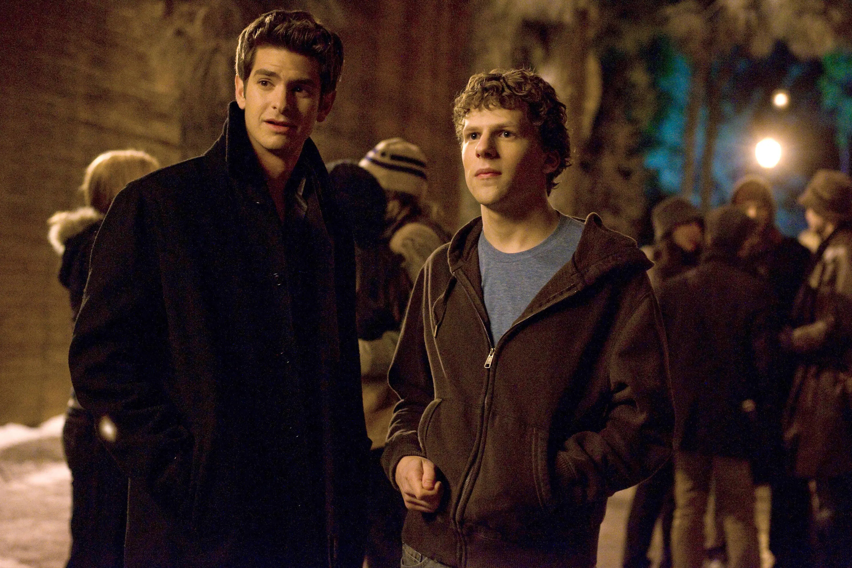 Andrew Garfield and Jesse Eisenberg stand outside together in The Social Network.