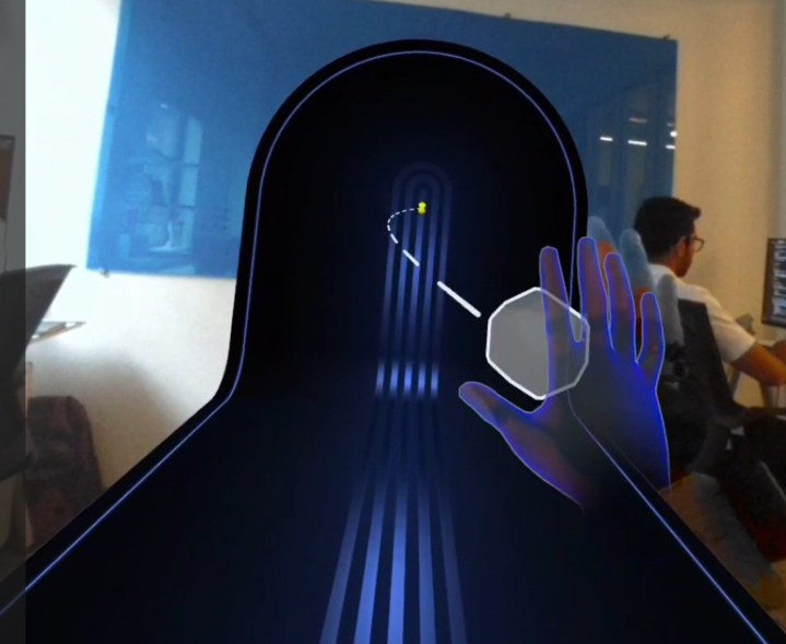 A hand grabbing an object in AR.