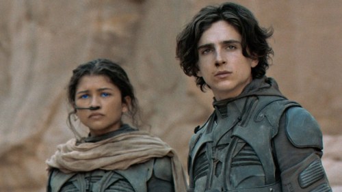 Zendaya and Timothée Chalamet as Chani and Paul looking to the distance in Dune.